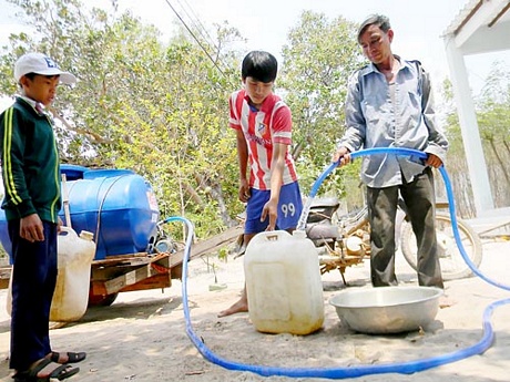 Người dân huyện Hàm Tân mua từng can nước sạch về sinh hoạt trong gia đình