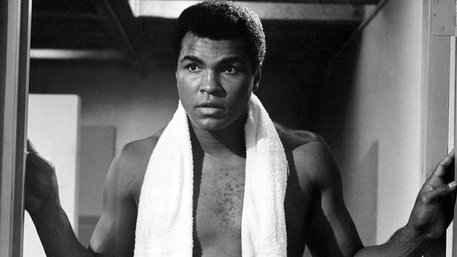 The Greatest (1977): Trong bộ phim tiểu sử năm 1977, đích thân Ali sắm vai bản thân và kể lại cuộc đời mình. Nội dung phim bao gồm nhiều cột mốc quan trọng, như chiến thắng tại Olympic của ông dưới tên Cassius Clay, việc chuyển tín ngưỡng sang đạo Hồi và đổi tên thành Muhammad Ali, sự kiện từ chối tham gia chiến tranh Việt Nam, những tranh chấp pháp lý sau khi ông bị tước đai vô địch thế giới… Ảnh: Columbia Pictures