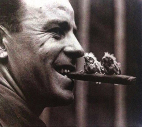 Một người đàn ông với điếu xì gà và hai con chim hoàng yến đậu ở trên, năm 1918.