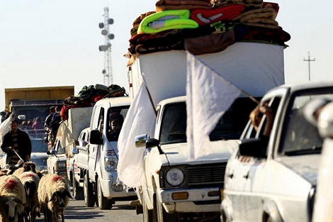Những chiếc xe xếp hàng qua chốt kiểm soát với những lá cờ trắng để rời khỏi vùng chiến sự Mosul.