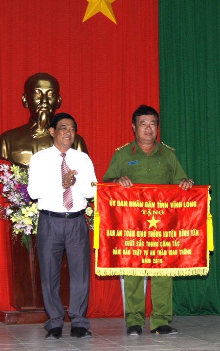  Ông Trần Hoàng Tựu- Phó Chủ tịch UBND tỉnh trao cờ thi đua xuất sắc cho Ban ATGT huyện Bình Tân.