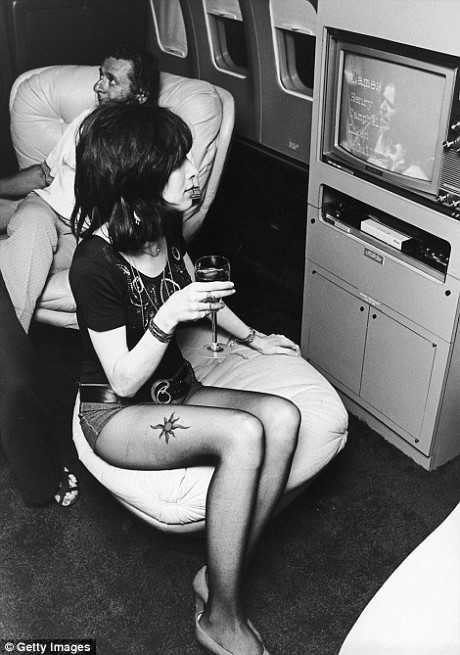 Một phụ nữ trẻ xem video trên máy bay Boeing 720B, năm 1973.