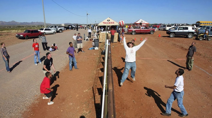 Người dân địa phương chơi bóng chuyền trên đường biên giữa Mỹ (bên trái) và Mexico (phía bên phải) (Ảnh: PsB).