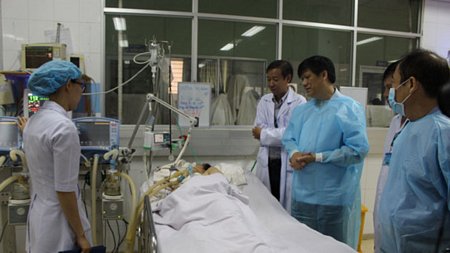 Thứ trưởng Bộ Y tế Nguyễn Thanh Long thăm một bệnh nhân sốt xuất huyết nặng đang điều trị tại Bệnh viện Bệnh Nhiệt đới (TPHCM).Ảnh: KHƯƠNG QUỲNH