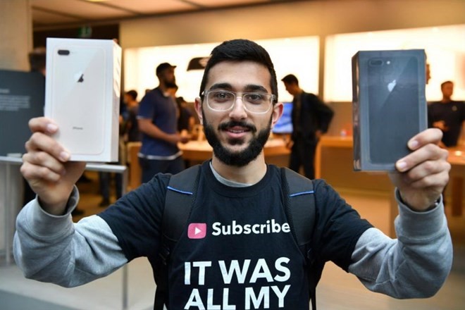 Một khách hàng vui mừng khoe hai chiếc iPhone 8 Plus sau khi mua tại của hằng Apple ở Syney trong ngày 22/9. (Nguồn: Reuters)