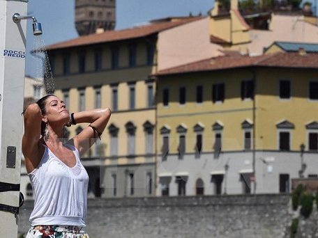 Khách du lịch làm mát bằng vòi nước công cộng khi nhiệt độ lên tới 40 độ C tại Florence, Italy ngày 1/8. (Nguồn: EPA/TTXVN)