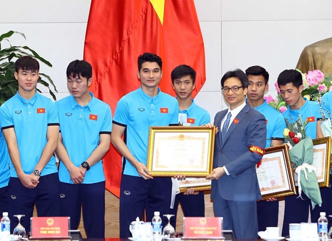 Phó Thủ tướng Vũ Đức Đam trao tặng Bằng khen của Thủ tướng Chính phủ cho các cầu thủ Đội tuyển U23 Việt Nam. (Ảnh: Thống Nhất/TTXVN)