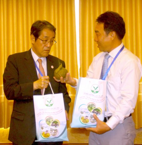 Ông Lữ Quang Ngời- Phó Chủ tịch UBND tỉnh giới thiệu với ngài Umeda Kunio- Đại sứ Nhật Bản tại Việt Nam những đặc sản của Vĩnh Long như khoai lang, cam sành… 