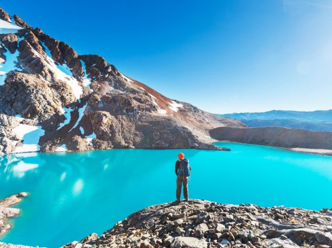 Du khách thưởng ngoạn phong cảnh xung quanh hồ nước trong xanh trên núi ở Parque Patagonia, Chile.