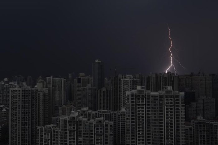 Tia chớp xé toạc bầu trời tối đen trên những tòa nhà chọc trời ở Thượng Hải (Trung Quốc) ngày 15/8/2012.