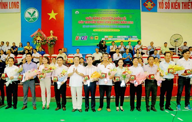 Ông Nguyễn Văn Diệp- nguyên Chủ tịch UBND tỉnh, Chủ tịch Liên đoàn Bóng chuyền tỉnh Vĩnh Long (đứng vỗ tay) trao hoa và tặng phẩm cho các nhà tài trợ mùa giải 2018.