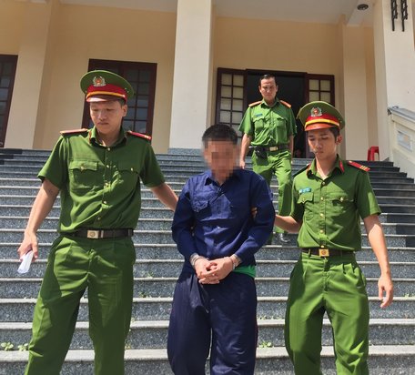 Công an áp giải bị cáo Phạm Thành Tài về trại tạm giam.