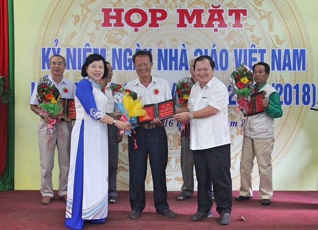 Chủ tịch UBND tỉnh- Nguyễn Văn Quang và Nhà giáo Nhân dân Đặng Huỳnh Mai trao khánh vàng tri ân các giáo viên kháng chiến.