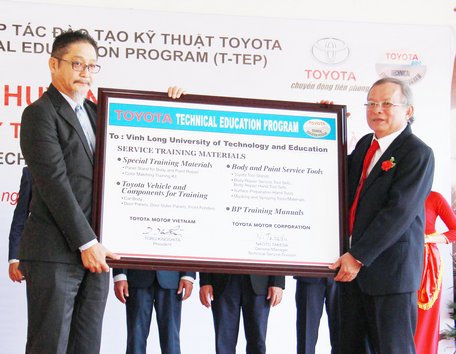 Ông Toru Kinoshita- Tổng Giám đốc Công ty Ô tô Toyota Việt Nam trao biểu trưng cho PGS.TS. Cao Hùng Phi- Hiệu trưởng Trường ĐH Sư phạm Vĩnh Long.