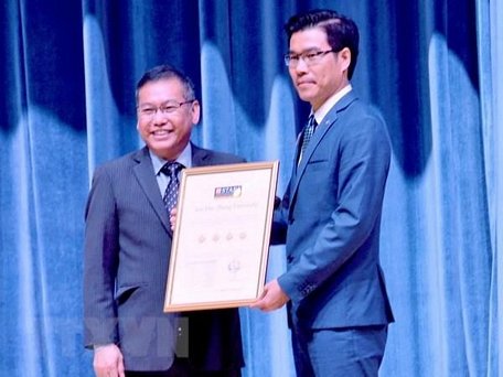 Đại diện QS Stars University Raitings (trái) trao chứng nhận xếp hạng 4 sao cho đại diện lãnh đạo Trường Đại học Tôn Đức Thắng. (Ảnh: Thu Hoài/TTXVN)