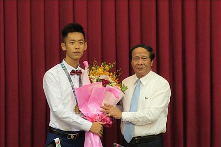 Nguyễn Thuận Hưng nhận phần thưởng của Bí thư Thành ủy thành phố Hải Phòng Lê Văn Thành, sau khi đoạt Huy chương vàng toán quốc tế IMO 2019. Ảnh: TTXVN phát