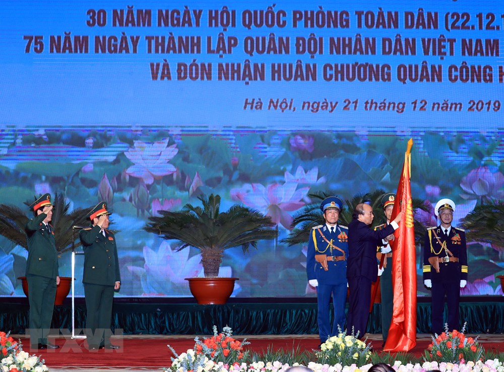  Thủ tướng Nguyễn Xuân Phúc, Chủ tịch Hội đồng thi đua-khen thưởng Trung ương trao tặng Huân chương Quân công hạng Nhất cho Bộ Quốc phòng. (Ảnh: Thống Nhất/TTXVN)