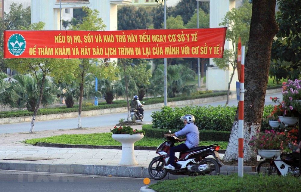  Băngrôn tuyên truyền, hướng dẫn người dân phòng, chống dịch COVID-19 trên đường Mê Linh, thành phố Vĩnh Yên. (Ảnh: Hoàng Hùng/TTXVN)