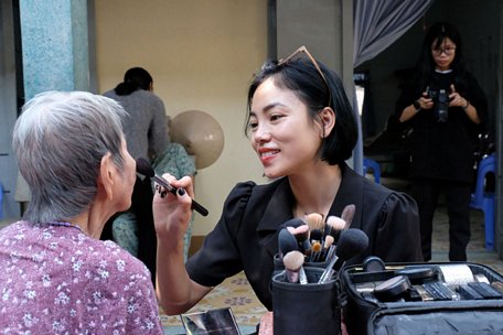 Chuyên gia makeup Vân Thị (29 tuổi) làm đẹp cho các cụ bà trước khi xuất hiện trước ống kính - ẢNH: VŨ THỦY