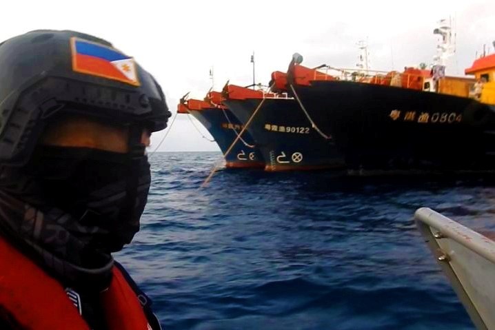 Xuồng tuần tra Philippines di chuyển gần nhóm tàu Trung Quốc đang neo đậu trái phép tại đá Ba Đầu - Ảnh: REUTERS