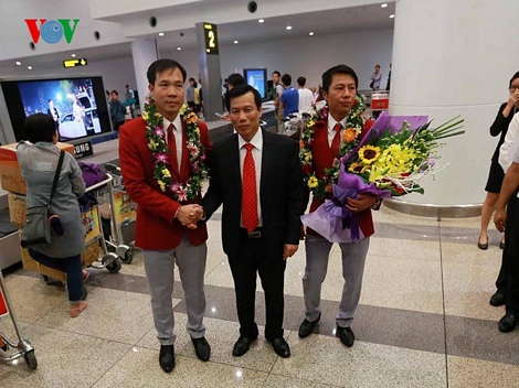 Bộ trưởng bộ VHTT&DL Nguyễn Ngọc Thiện chào mừng xạ thủ Hoàng Xuân Vinh ngay khi anh vừa đặt chân xuống sân bay Nội Bài. 