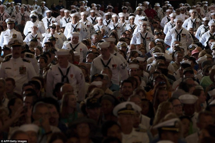 Thành viên thủy thủ đoàn cùng gia đình lắng nghe phát biểu của Tổng thống Mỹ Donald Trump nhân lễ bàn giao tàu sân bay USS Gerald R. Ford. Ảnh: AFP.