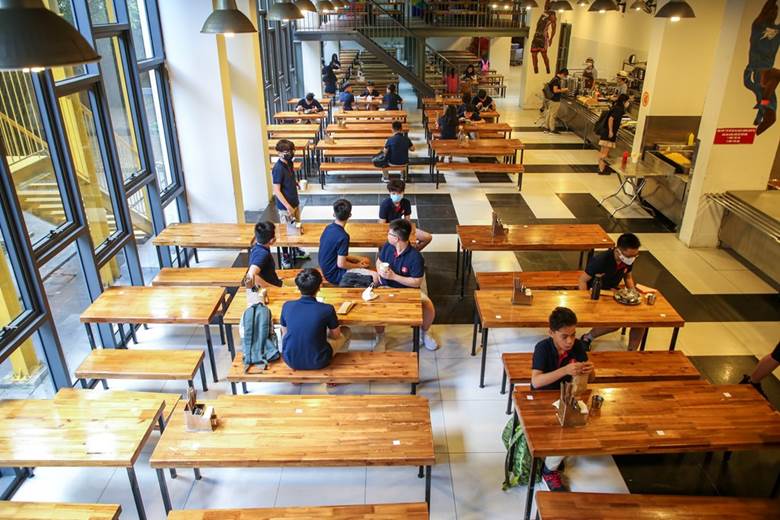  Học sinh ăn uống tại khu vực nhà ăn của nhà trường cũng được khuyến cáo giữ khoảng cách tối thiểu để phòng dịch. (Ảnh: Minh Sơn/Vietnam+)