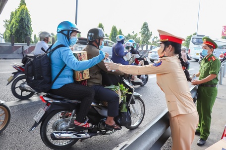 Thượng úy Nguyễn Lê Mỹ Nhân cùng đồng đội phát nước suối hỗ trợ người đi đường.