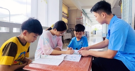 Nhân viên Bùi Thắng Cảnh cùng ôn bài với các cô cậu trò ở khu trẻ đi học.