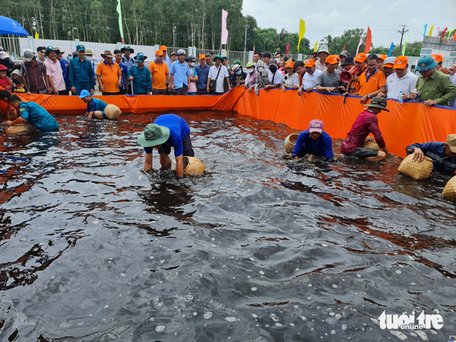 Hội thi bắt lươn được đông đảo du khách tham gia - Ảnh: THANH HUYỀN