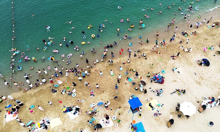 Người dân tìm tới bãi biển tại thành phố Thâm Quyến, tỉnh Quảng Đông, Trung Quốc giữa đợt nắng nóng vào ngày 1/6 - Ảnh: VCG