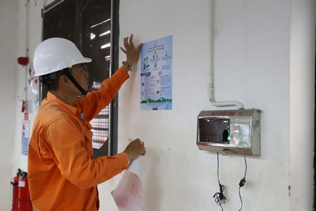Công ty Điện lực Vĩnh Long dán bảng hướng dẫn tiết kiệm điện ở các đơn vị sản xuất.