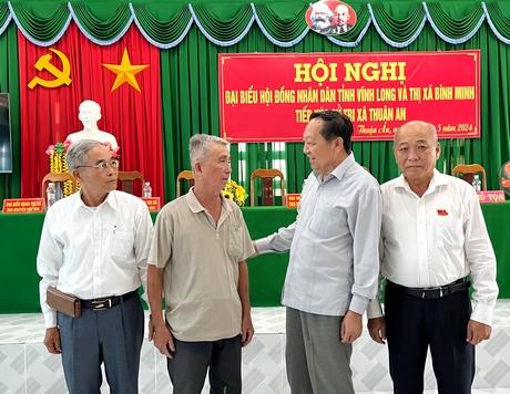 Ông Nguyễn Thành Thế- Phó Bí thư Thường trực Tỉnh ủy trao đổi với cử tri xã Thuận An bên lề buổi tiếp xúc.