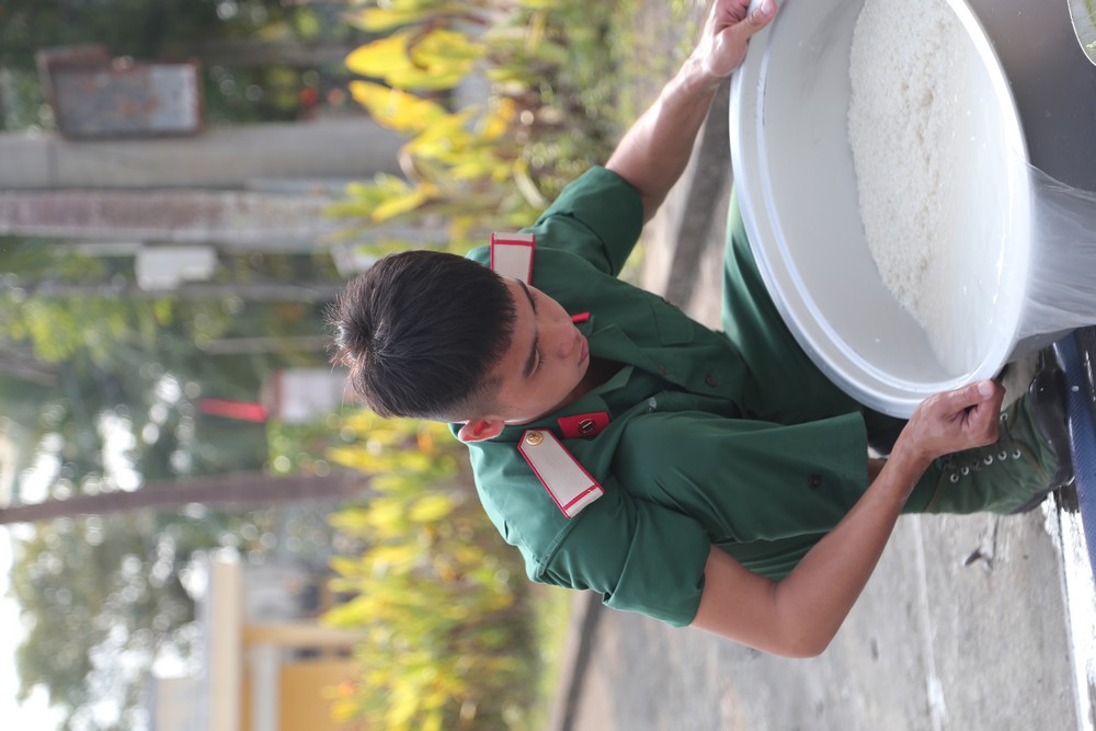Chiến sĩ vo gạo, tích cực chuẩn bị bữa cơm Tết Quân dân.