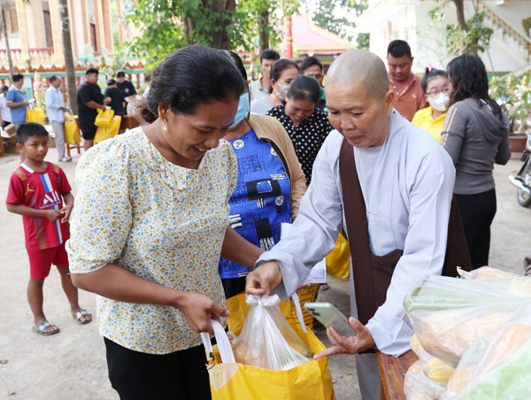 Sư cô Thích Nữ Huệ Thủy- trụ trì chùa Tân Long (xã Trà Cú) tặng quà cho người dân tham gia “Chợ tết 0 đồng”.


