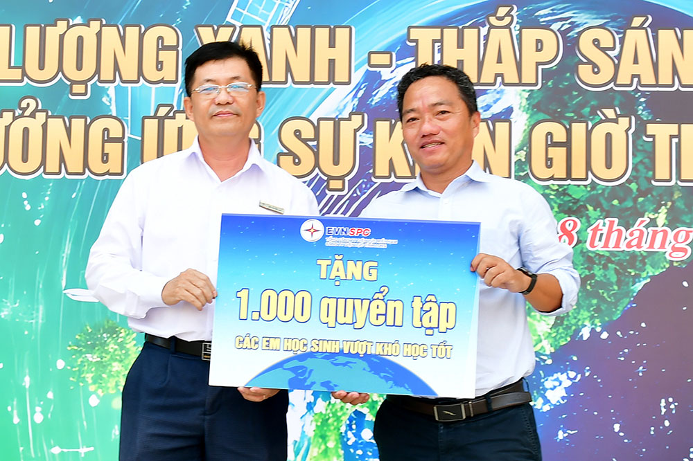 Ông Bùi Văn Việt Hòa- Trưởng Điện lực Trà Vinh (trái) trao tượng trưng 1.000 quyển tập tặng học sinh Trường THPT Phạm Thái Bường.