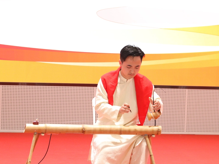 Nghệ sĩ đàn bầu Đinh Tiến Sinh trình diễn đàn bầu trong một buổi giao lưu của thanh niên hai nước - Ảnh: TRỌNG NHÂN

