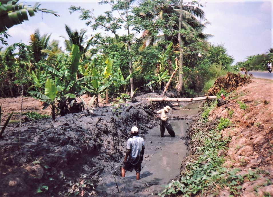 Không có máy đào cỡ nhỏ, nông dân vẫn còn chọn cách vét mương, vũng bằng thủ công.