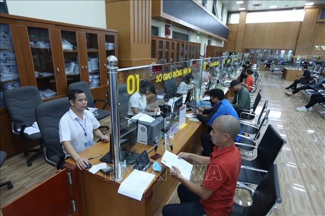 
Tiếp nhận và giải quyết hồ sơ của các sở, ban, ngành tại Trung tâm Phục vụ hành chính công tỉnh Bắc Giang. Ảnh: Danh Lam/TTXVN