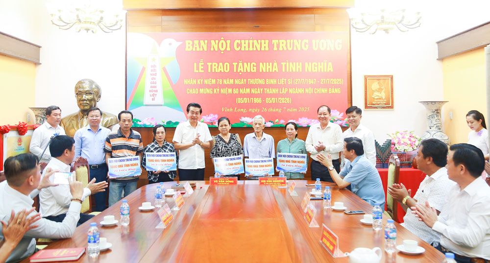 Đồng chí Võ Văn Dũng trao bảng tượng trưng kinh phí xây dựng nhà tình nghĩa cho các gia đình chính sách.
