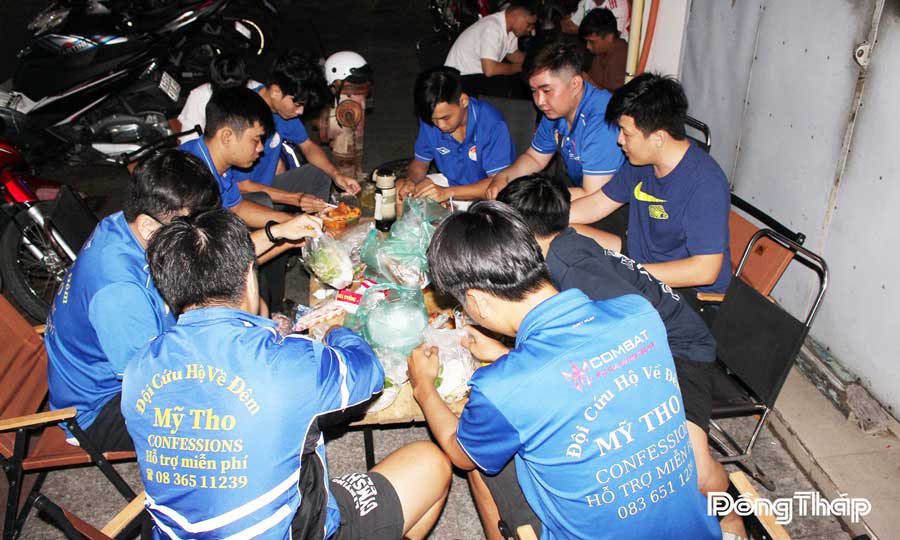 Các thanh niên cứu hộ “bạn đường” vào đêm khuya tranh thủ bữa ăn vội để có đủ sức làm nhiệm vụ.