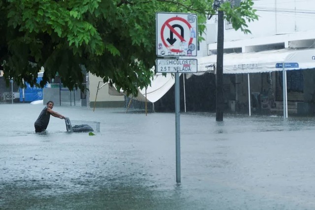 Một người đàn ông đẩy xe đẩy trên con phố ngập lụt trong trận mưa do bão Helene gây ra, ở Cancun, Mexico, ngày 25/9/2024. Ảnh: Reuters