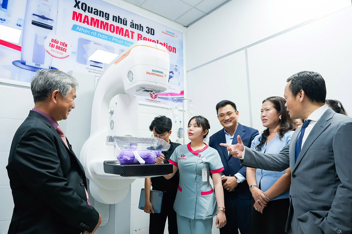 Các đại biểu tham quan, nghe giới thiệu về cơ chế vận hành của hệ thống X-quang nhũ ảnh 3D MAMMOMAT Revelation tích hợp trí tuệ nhân tạo.