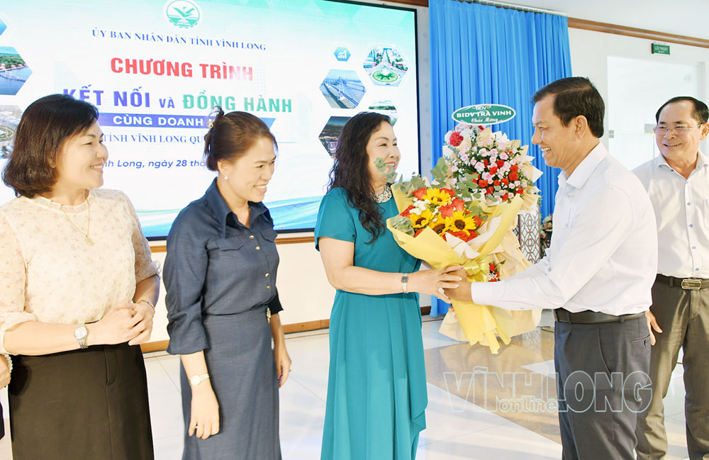 Phó Chủ tịch Thường trực UBND tỉnh Đặng Văn Chính tặng hoa chúc mừng các doanh nghiệp nữ tham gia Chương trình.