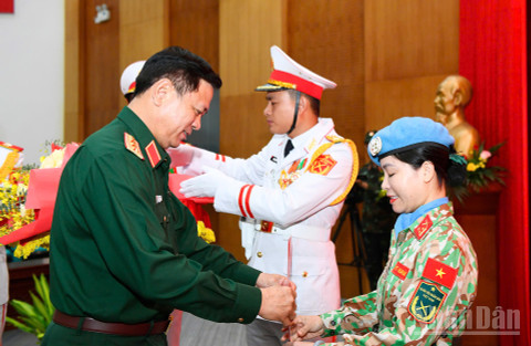 Thượng tướng Nguyễn Trường Thắng trao quyết định cho hai sĩ quan lên đường làm nhiệm vụ. (Ảnh: THẾ ĐẠI)
