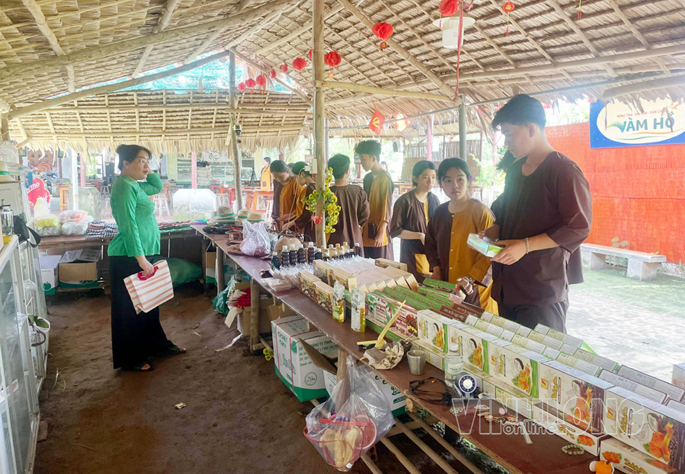 Các em học sinh mua sản phẩm lưu niệm của địa phương tại Nông trại Hải Vân - Sân chim Vàm Hồ.