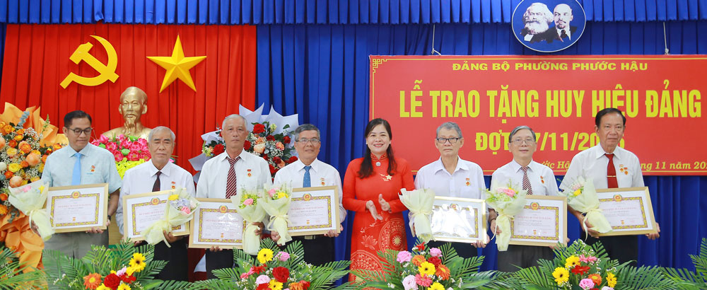 Đồng chí Nguyễn Thị Hồng Hoa- Bí thư Đảng ủy phường Phước Hậu trao Huy hiệu Đảng cho các đảng viên.
