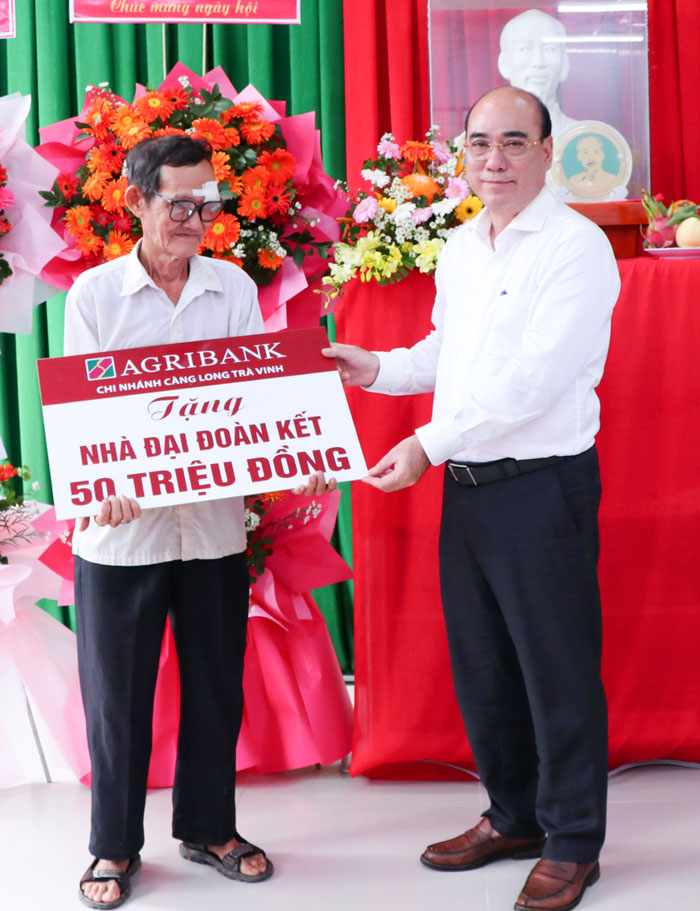 Đồng chí Nguyễn Văn Tuấn- Ủy viên Ban Thường vụ Tỉnh ủy, Phó Chủ tịch HĐND tỉnh trao bảng tượng trưng nhà Đại đoàn kết cho hộ dân.