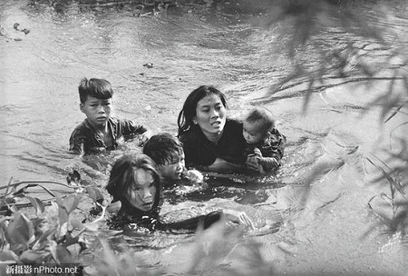 1965: Một người mẹ đang cùng các con bơi qua sông để thoát khỏi cuộc ném bom của những máy bay Mỹ.