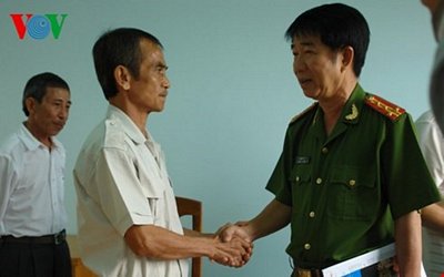 Đại tá Phạm Thật - Thủ trưởng Cơ quan Cảnh sát điều tra, Công an tỉnh Bình Thuận bắt tay ông Huỳnh Văn Nén tại buổi công bố quyết định đình chỉ điều tra bị can.